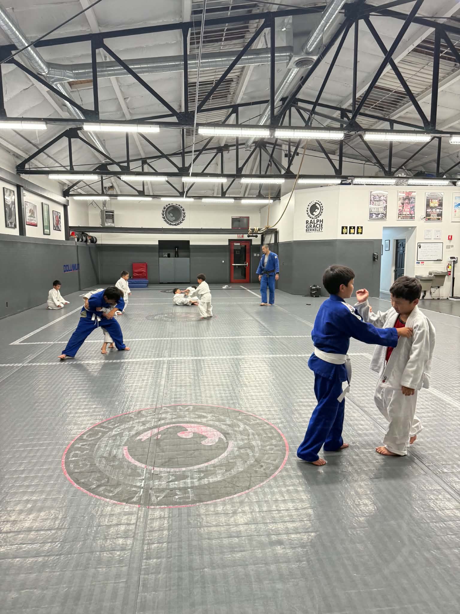 Children practicing judo with partners at our Berkeley dojo